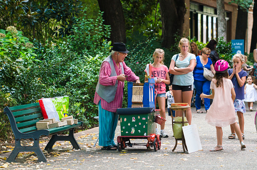 TOULOUSE, FRANCE - OCTOBER 4, 2014: A man with a pianola, plays old French songs in a city park.