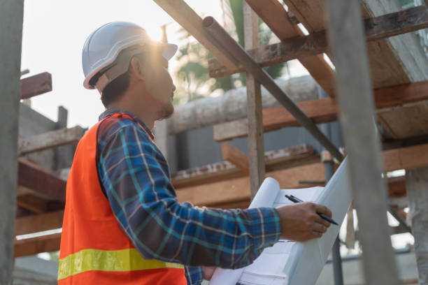 istock inspector or engineer is inspecting construction and quality assurance new house using a blue print. Engineer or architects or contactor work to build the house before handing it over to the homeowner 1500064697