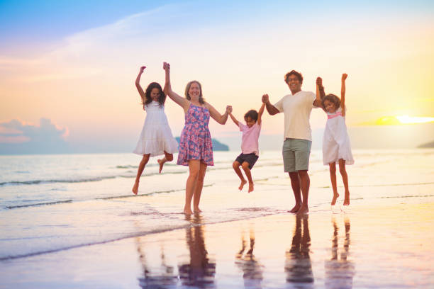 istock Family walking on tropical beach at sunset 1500066421