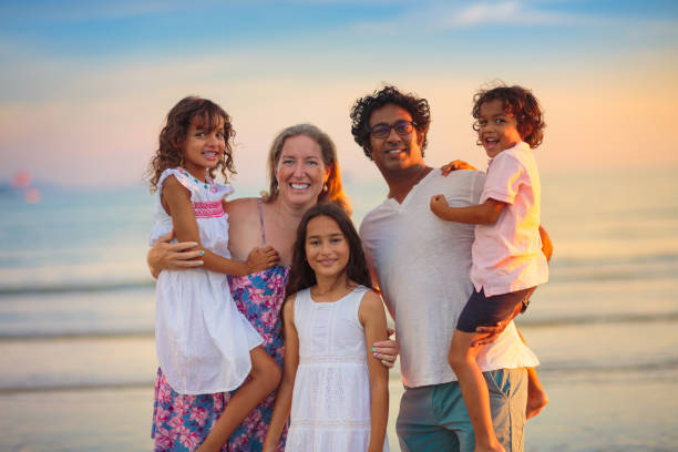 istock Family walking on tropical beach at sunset 1500066607
