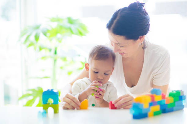 istock Baby boy  and mother playing with toy 1500066681