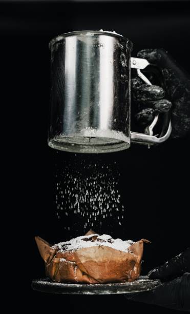 Bowl with flour on the background of a bottle of oil. Macro