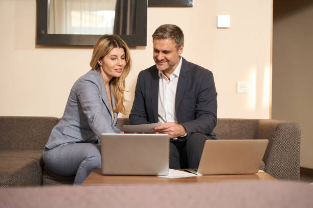 istock Male and female looking on computer in the hotel 1500069762