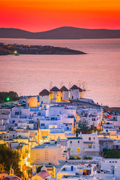 Mykonos, Greece. Sunset over Aegean Sea and the famous windmill from above, Cyclades. stock photo