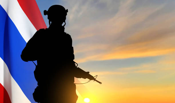 istock Silhouette of a soldier with Thai flag against the sunset. Patriotic concept 1500070430