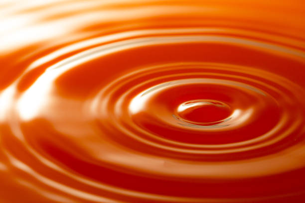 istock Macro orange drop,Macro orange water drop texture,Falling drop in orange water with splash,The waves after a few drops of orange juice 1500071612