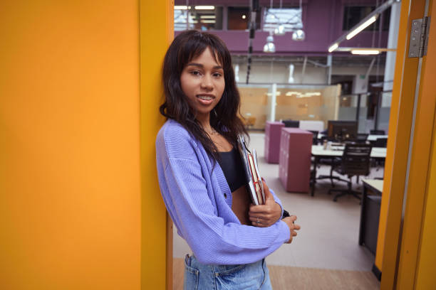 istock Beautiful female posing at camera in modern office 1500074086