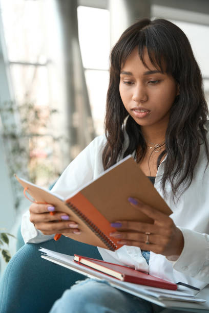 istock Brunette female reviewing notes in modern room 1500074106