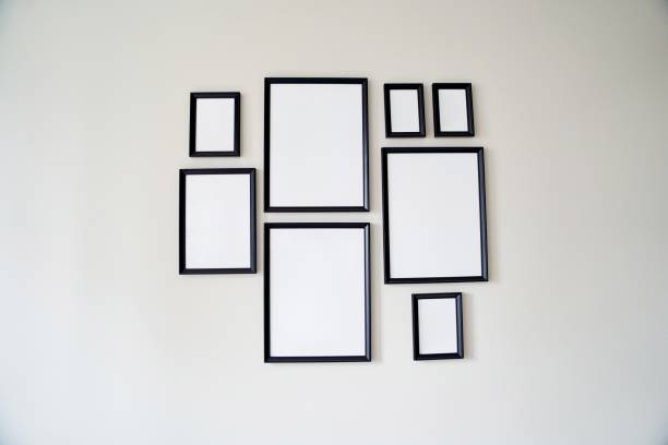 istock Different size framed photos hanging on the gray wall. Mockup. 1500074425