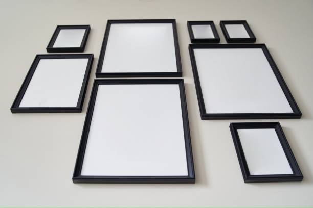 istock Different size framed photos hanging on the gray wall. Mockup. 1500074649
