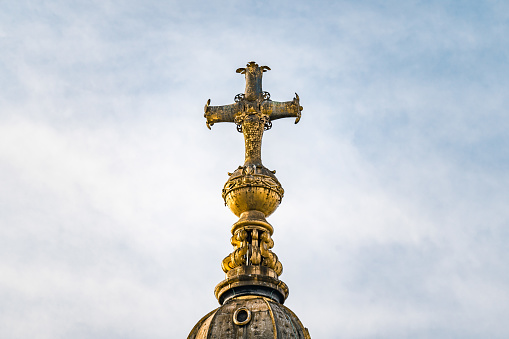 Close up of the gold cross on the top of St Pauls Cathedral, London, UK