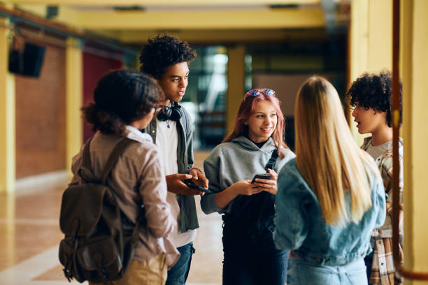 istock Multiracial group of happy high school students talking in a hallway. 1500076682