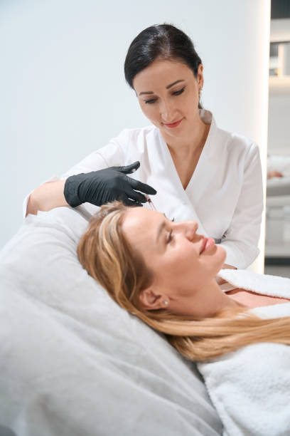 istock Beautician in uniform performs an injection procedure around the eyes 1500080907