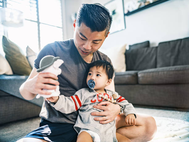 istock Young Korean Father at Home playing with toddler son 1500083043