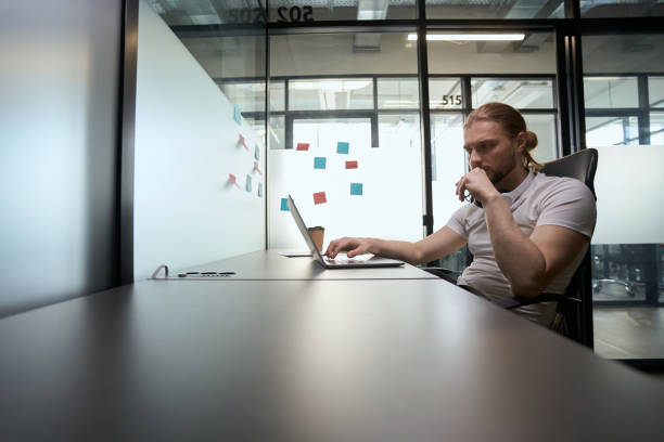 istock Thoughtful man sits at his desk in front of laptop 1500084847