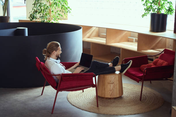 istock Young man is located in a recreation area with laptop 1500084884