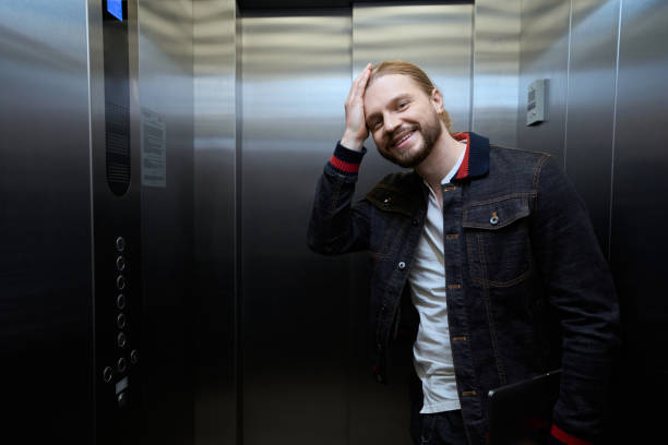 istock Guy in a denim jacket is in the passenger elevator 1500084914
