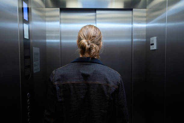 istock Male in a denim jacket is in passenger elevator cabin 1500084918