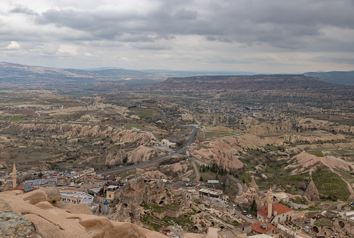 A picture of the Goreme Historical National Park, and the town of Uchisar, on a cloudy day.