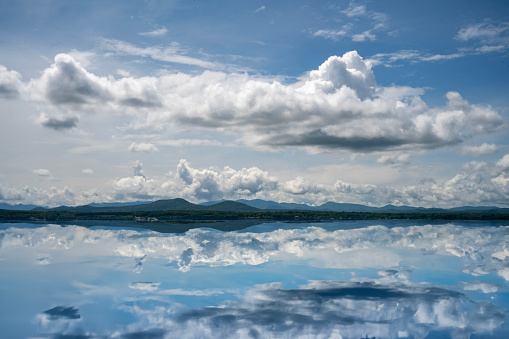 Adirondack mountains with clouds and reflections on the water of Lake Champlain