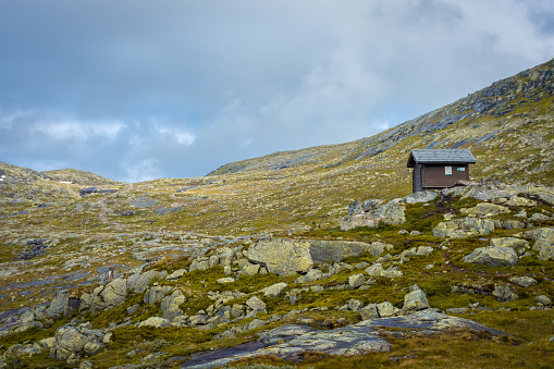 Wooden hut in the Norwegian mountains, moody landscape in the trail for Trolltunga