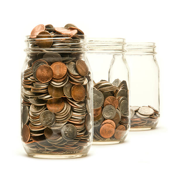 istock Three glass jars filled with American coins 150008870