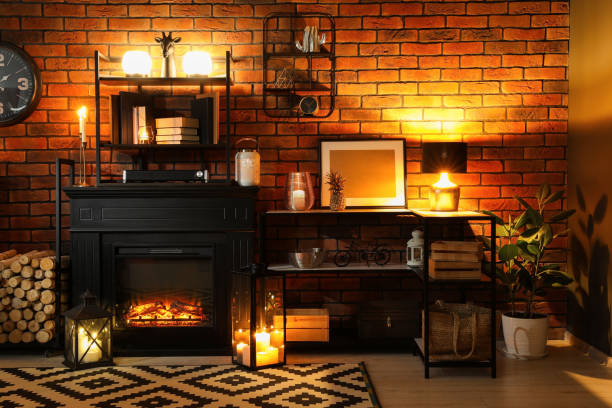 istock Stylish living room with beautiful fireplace and different decor at night. Interior design 1500091221