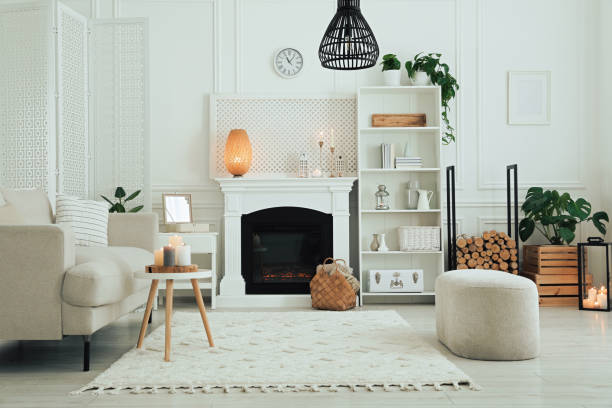 istock Stylish living room with beautiful fireplace, sofa and different decor. Interior design 1500091252