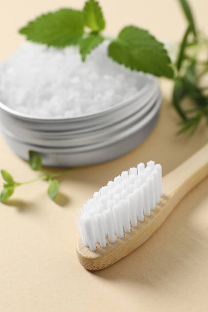 istock Toothbrush, salt and herbs on beige background, closeup. 1500091285