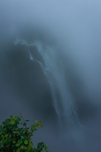 View of the Voringfossen waterfall in the deep fog, Norway