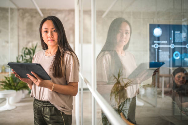 istock Focused Asian Female Embracing Digital Technology in the Office 1500092638