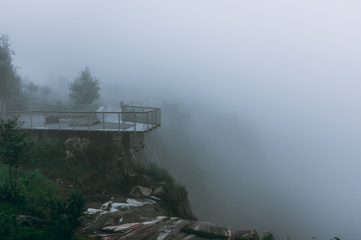 Platform to admire the Voringfossen Waterfall in Norway in deep fog