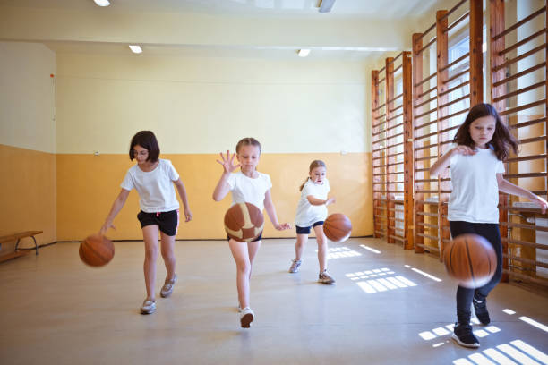 istock School girls practicing dribbling during sport lesson 1500093022