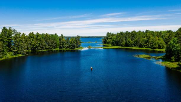 istock Scenic lake with a canoe floating on the calm, blue waters 1500095309