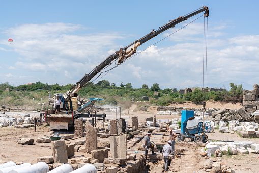Side,Manavgat ,Turkey : June 6 2023 The ancient city of Side is being restored with the help of archaeologists and a crane