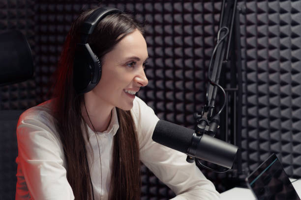 istock Cheerful woman speaking during radio broadcast 1500096623