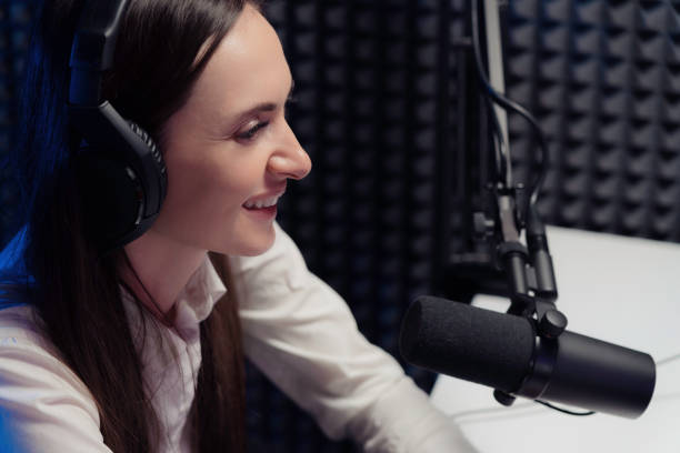 istock Cheerful woman speaking during radio broadcast 1500096652