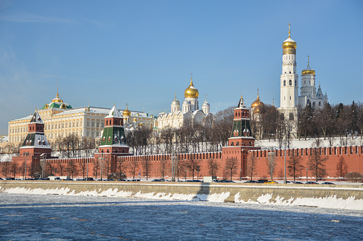 Nice view of the town at sunset. Orthodox church surrounded by beautiful red brick buildings on the city's waterfront. Volga region of Russia, the city of Yoshkar-Ola