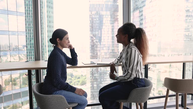 Two diverse young business colleagues meeting in office lobby