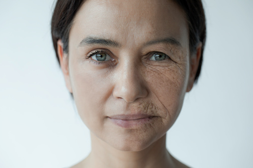 Composite image of a woman with green eyes when she was young and old in front of white background.