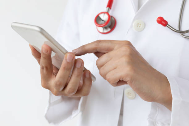 istock Female Doctor using Phone 1500099186