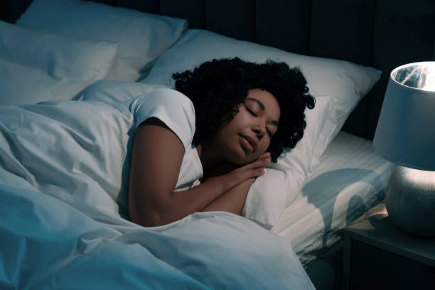 istock Young woman sleeping in soft bed at night 1500099362