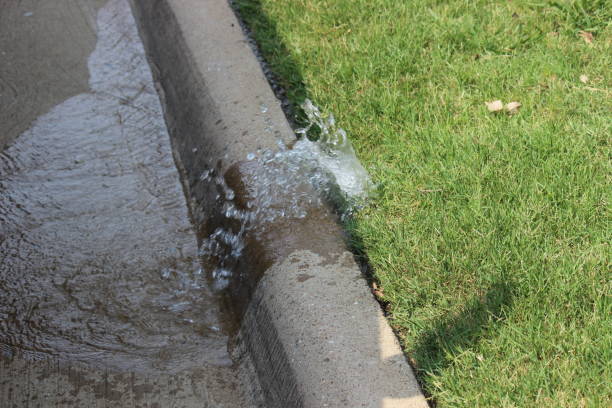 Water leaking from broken lawn sprinkler head