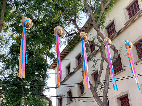 Village street decorated with hats hung with colored ribbons