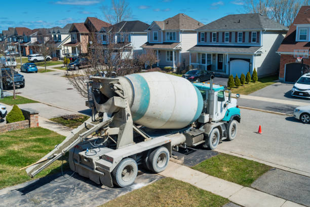 Cement truck during the construction of a concrete deck at a house.