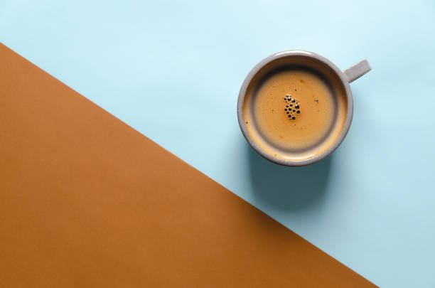 istock A cup of coffee on blue and brown background. 1500115222