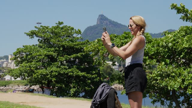 Woman taking a scenic video by Christ the Redeemer in Rio