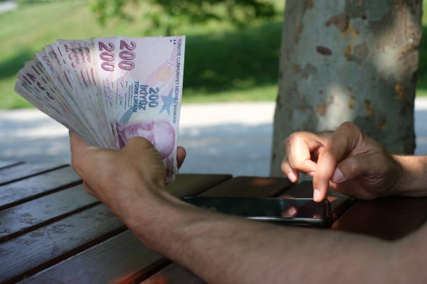 istock Making account book on table outdoors with phone and money in the same frame 1500117583