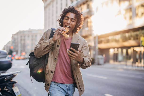 istock Man eating on the street 1500117687