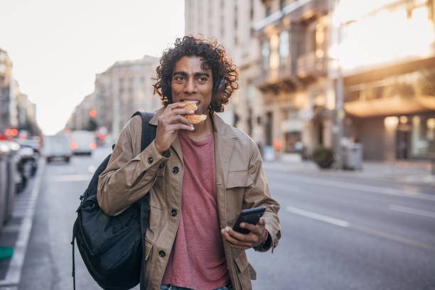 istock Man eating on the street 1500117799